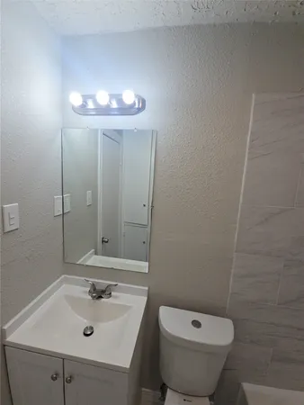 a bathroom with a sink and mirror