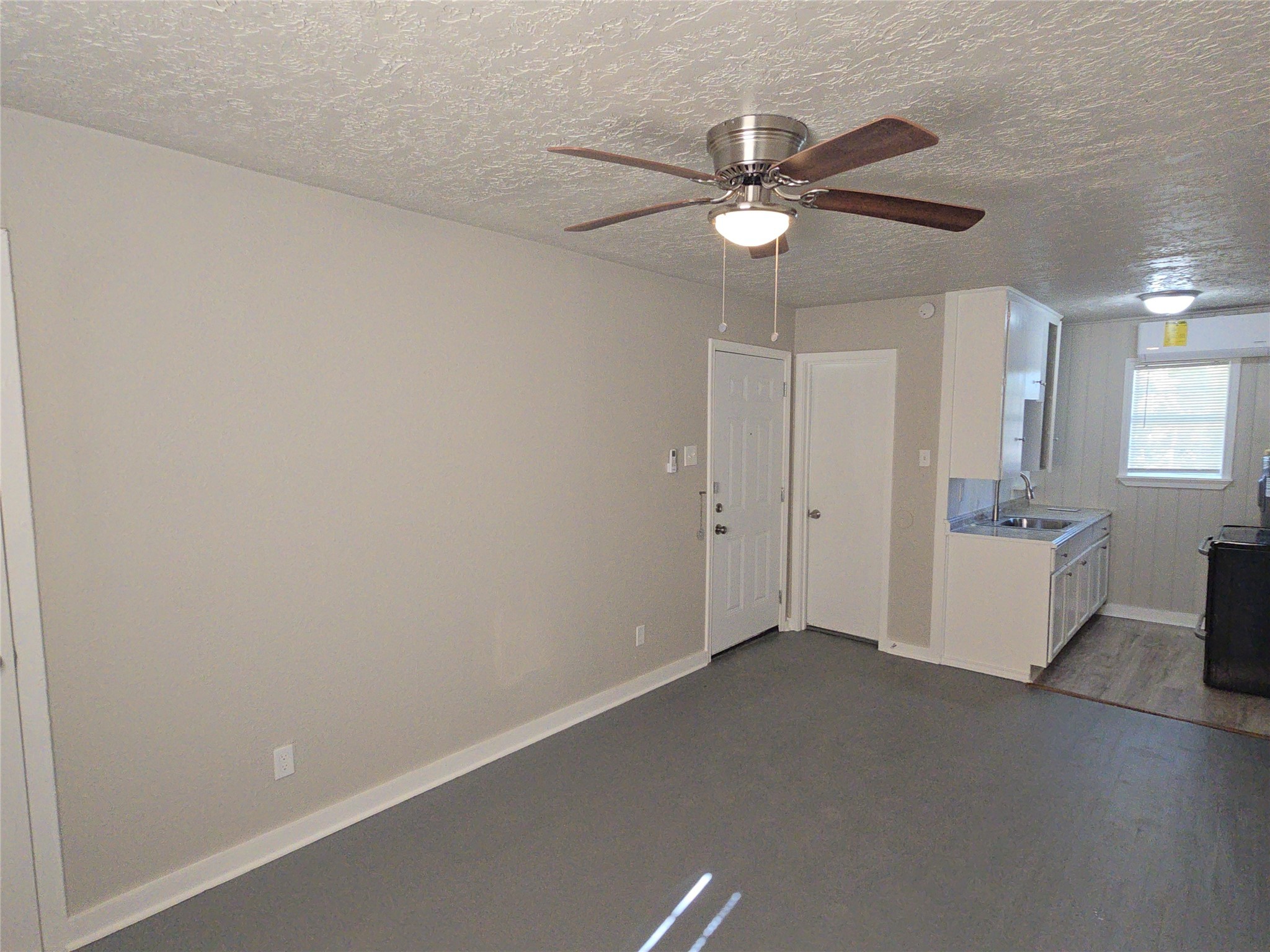 3335 Tuam Street, Unit 3 Houston, TX 77004 - Photo 2 of 16 an empty room with a chandelier fan and windows