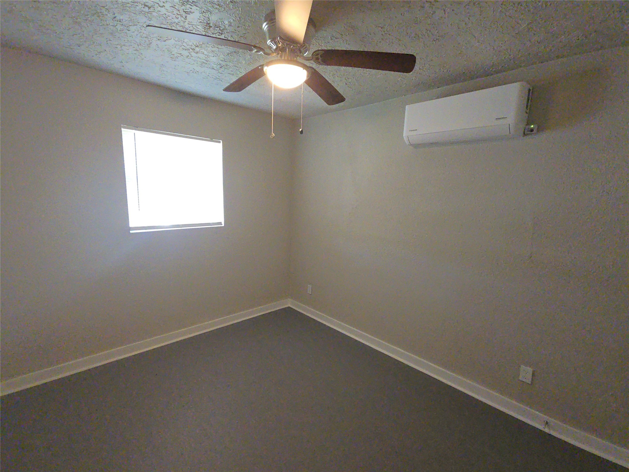3335 Tuam Street, Unit 3 Houston, TX 77004 - Photo 5 of 16 an empty room with a window and a fan