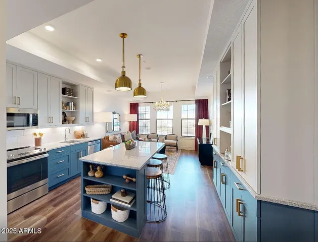 a large kitchen with a table and chairs