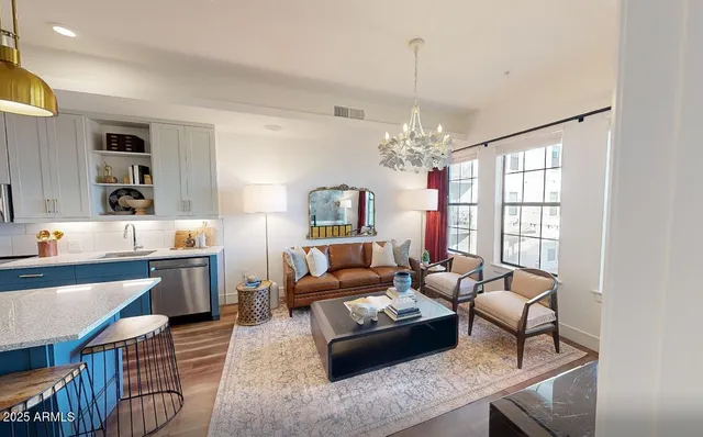 a living room with furniture and a chandelier
