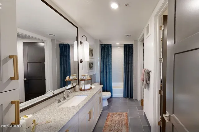 a large bathroom with a double vanity sink and mirror