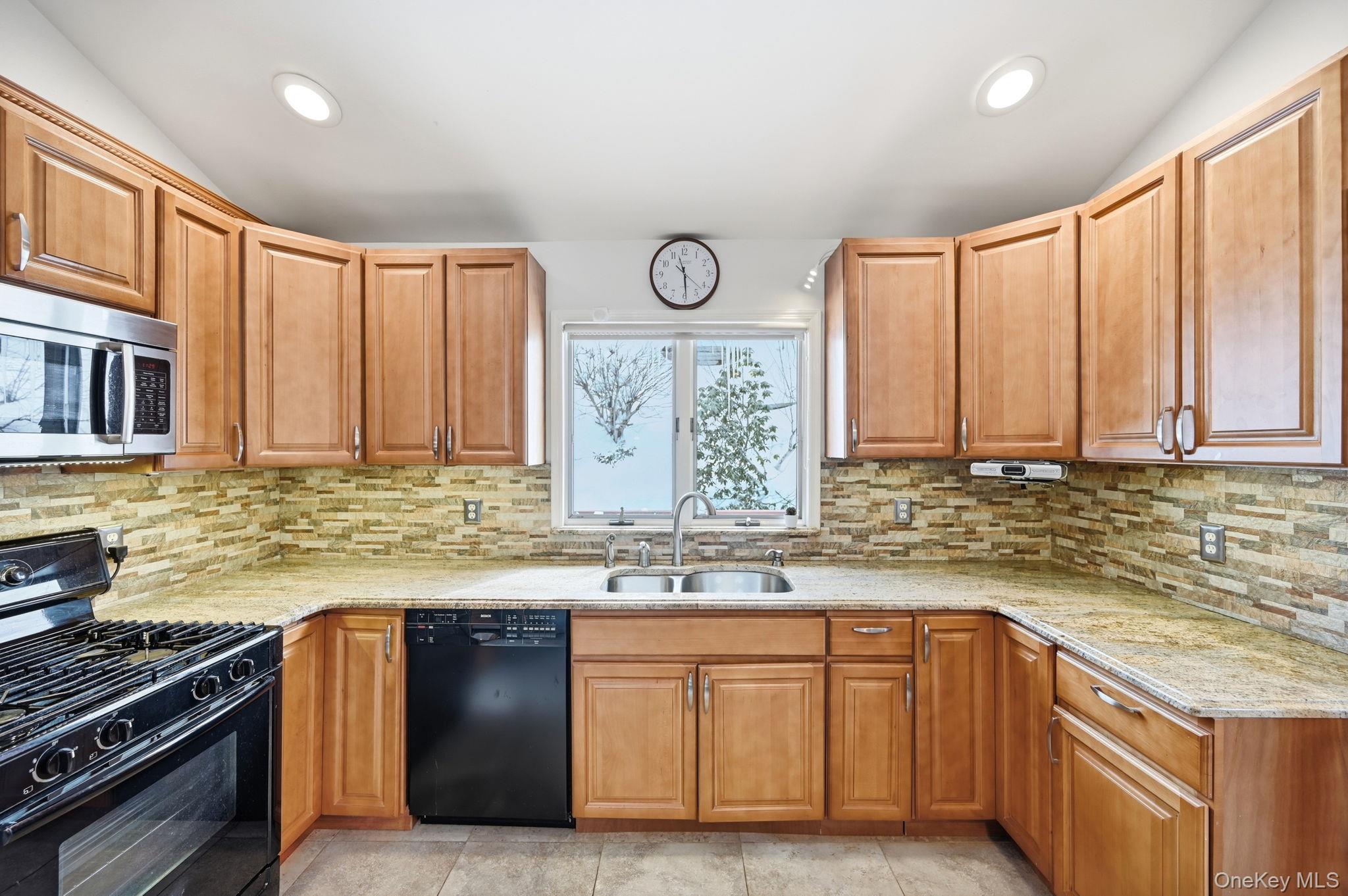10 Pine Brook Road Ossining, NY 10562 - Photo 13 of 48 a kitchen with stainless steel appliances granite countertop a sink a stove and a wooden cabinets