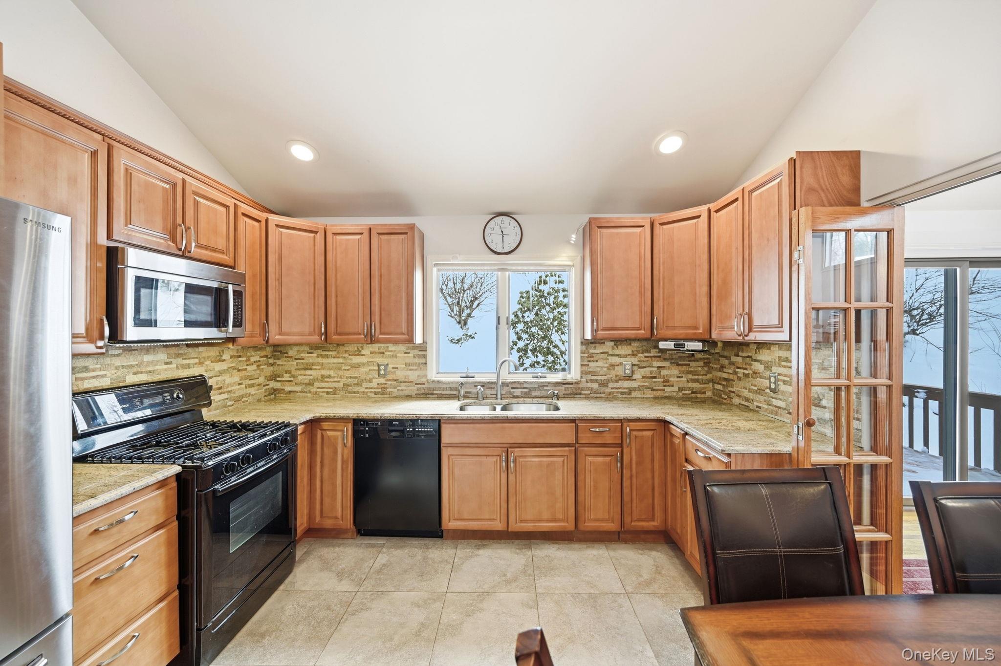 10 Pine Brook Road Ossining, NY 10562 - Photo 14 of 48 a kitchen with stainless steel appliances granite countertop a stove top oven a sink dishwasher and cabinets with wooden floor