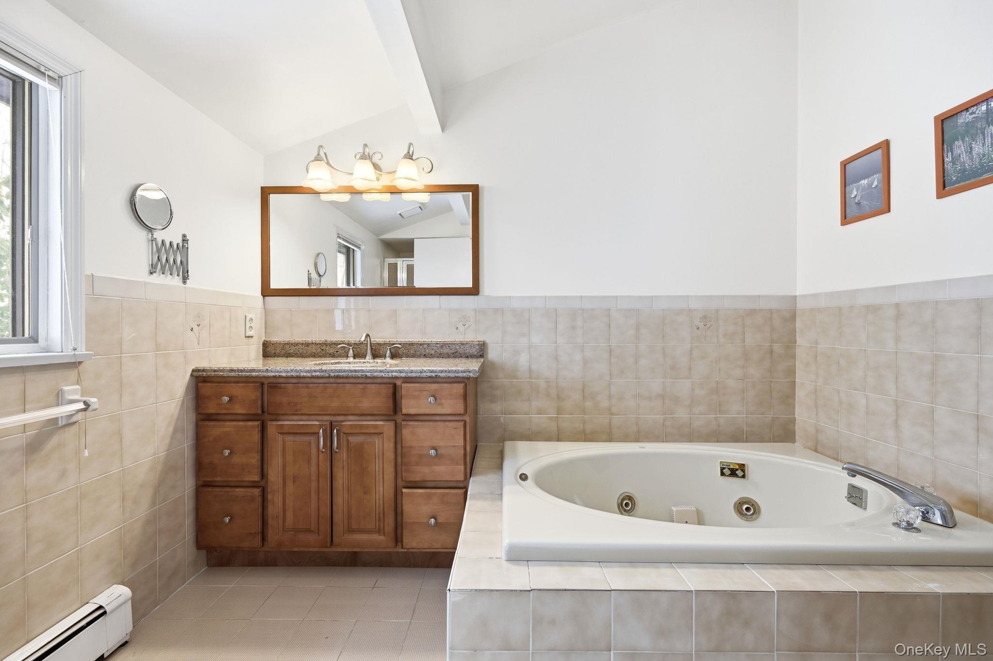 10 Pine Brook Road Ossining, NY 10562 - Photo 20 of 48 a bathroom with a tub sink and mirror