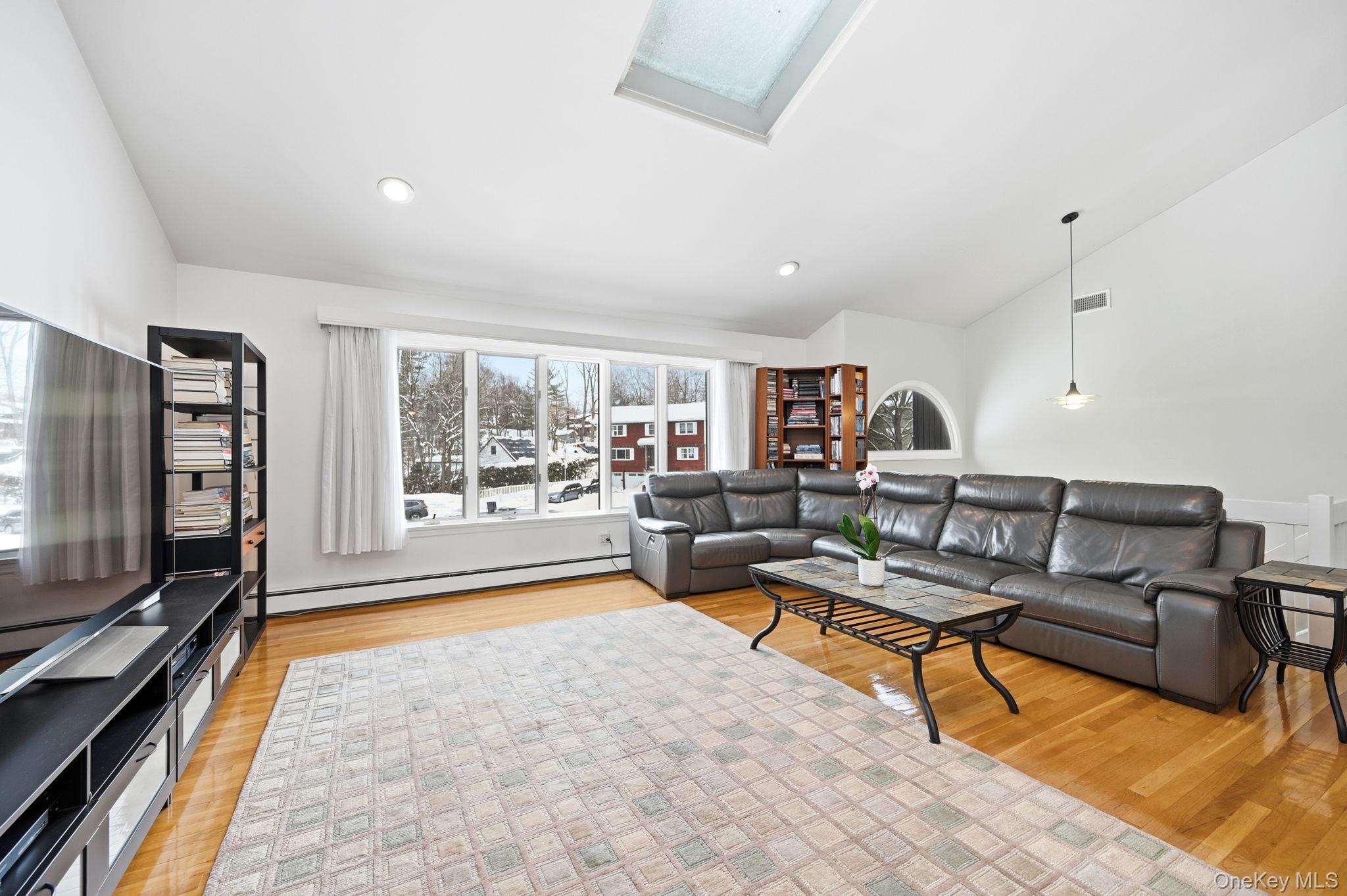 10 Pine Brook Road Ossining, NY 10562 - Photo 6 of 48 a living room with furniture and a flat screen tv