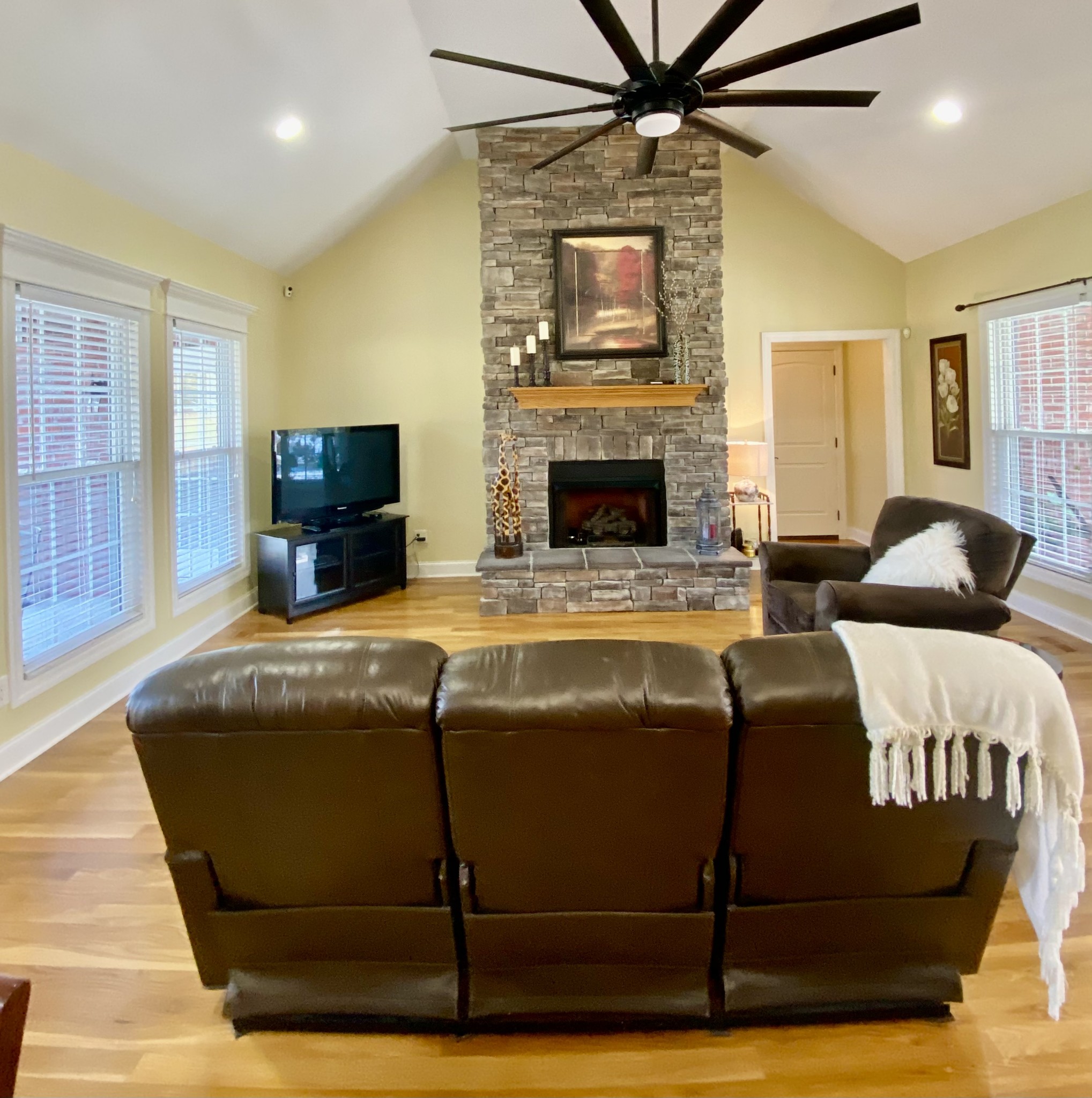 1134 John Sharp Road Spring Hill, TN 37174 - Photo 9 of 41 a living room with furniture a flat screen tv and a fireplace