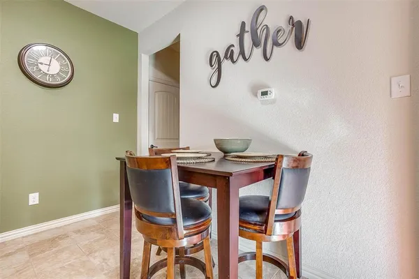 a kitchen with a stove sink and windows