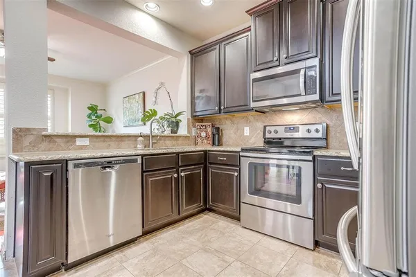 a view of kitchen with window and stainless steel appliances