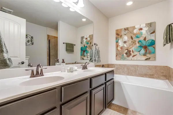 a bathroom with a bathtub and shower