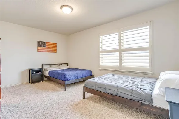 a bathroom with a tub a sink and a large mirror