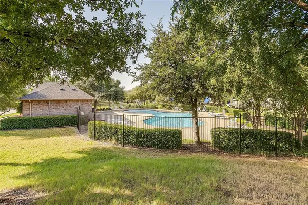 a view of a house with garden and a tree