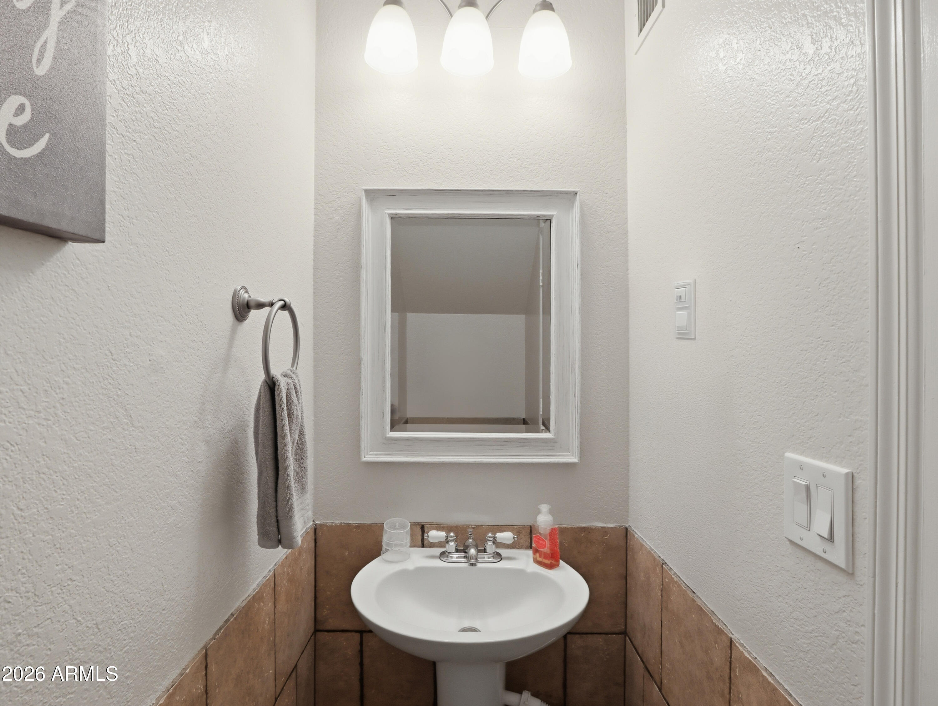 1402 East Osborn Road, Unit 2 Phoenix, AZ 85014 - Photo 6 of 29 a bathroom with a sink and a mirror