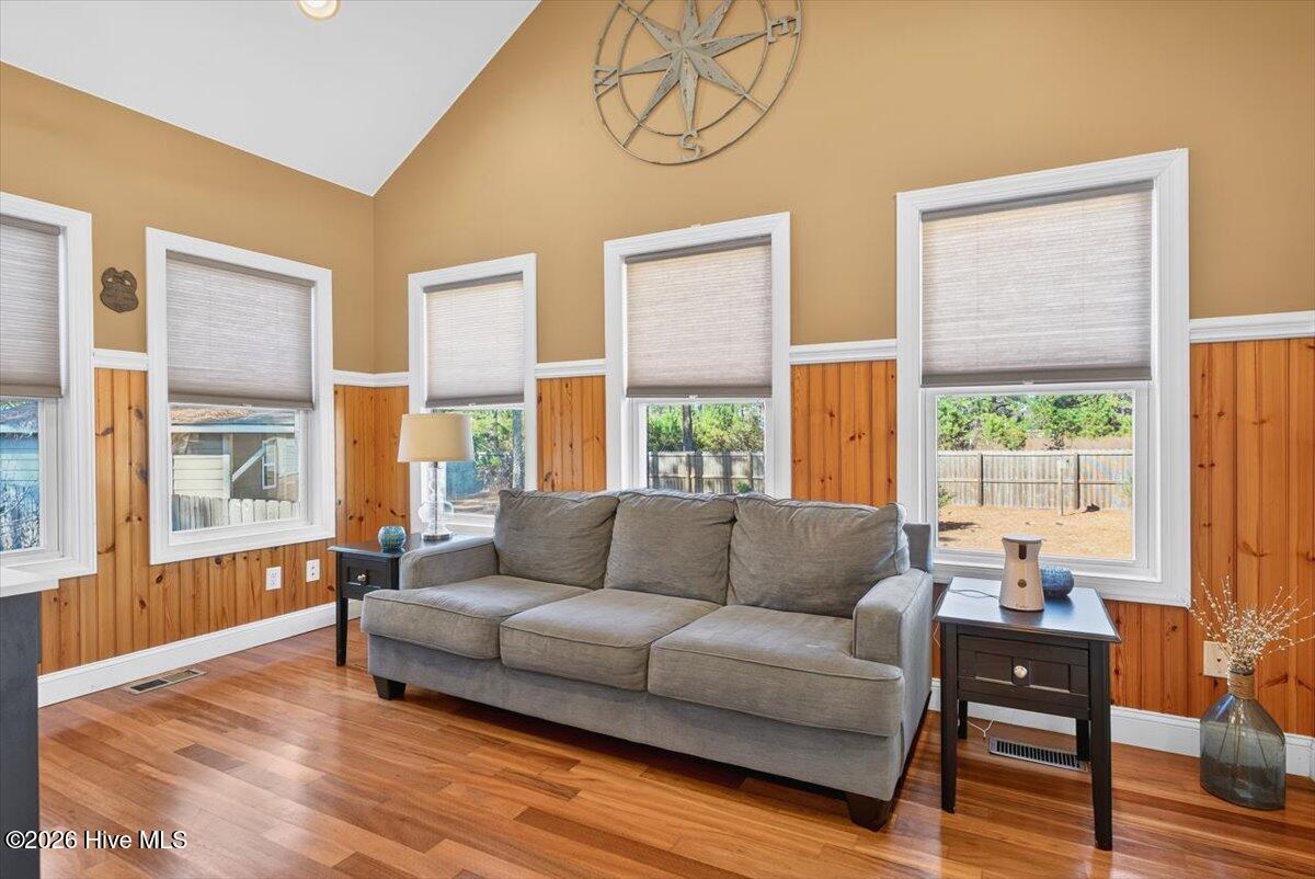18 Brierwood Road Southwest Shallotte, NC 28470 - Photo 27 of 70 Bright and inviting sitting area with large windows, hardwood floors, and abundant natural light.