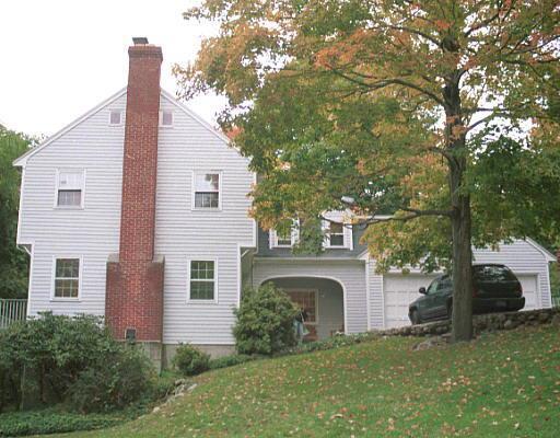 617 Ridgefield Road Wilton, CT 06897 - Photo 1 of 1 a front view of a house with a garden and yard