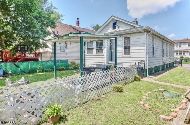 a front view of a house with a garden and plants