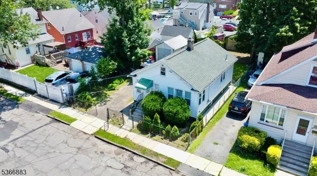 an aerial view of a house with a yard and potted plants