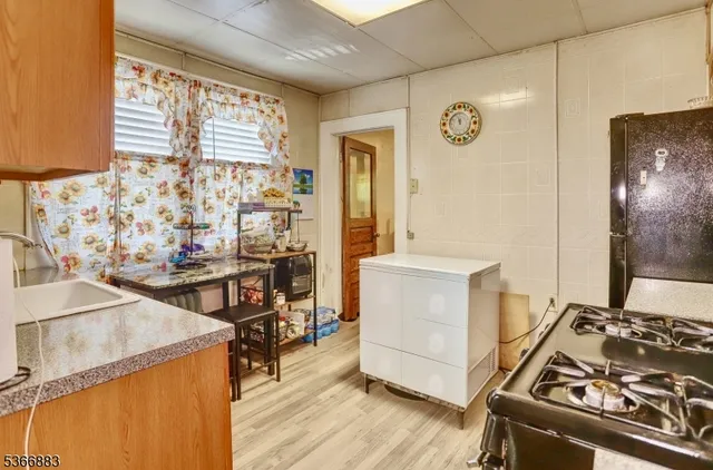a view of a kitchen with table and chairs