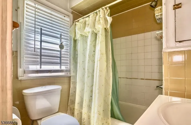 a bathroom with a toilet and shower