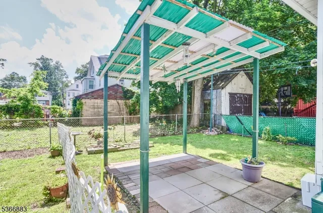 a view of a house with backyard and porch