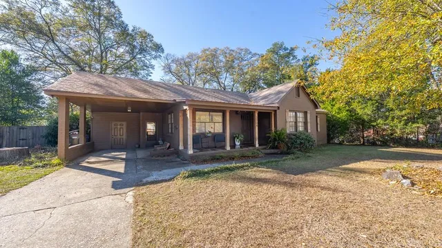 a front view of a house with garden and porch