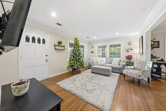 a living room with furniture and wooden floor