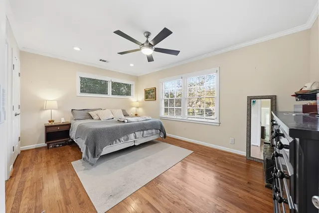 a bedroom with a large bed and a window