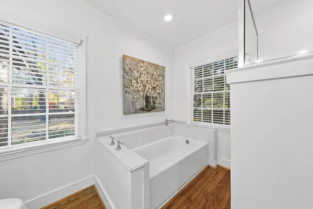 a bathroom with a bathtub and a window