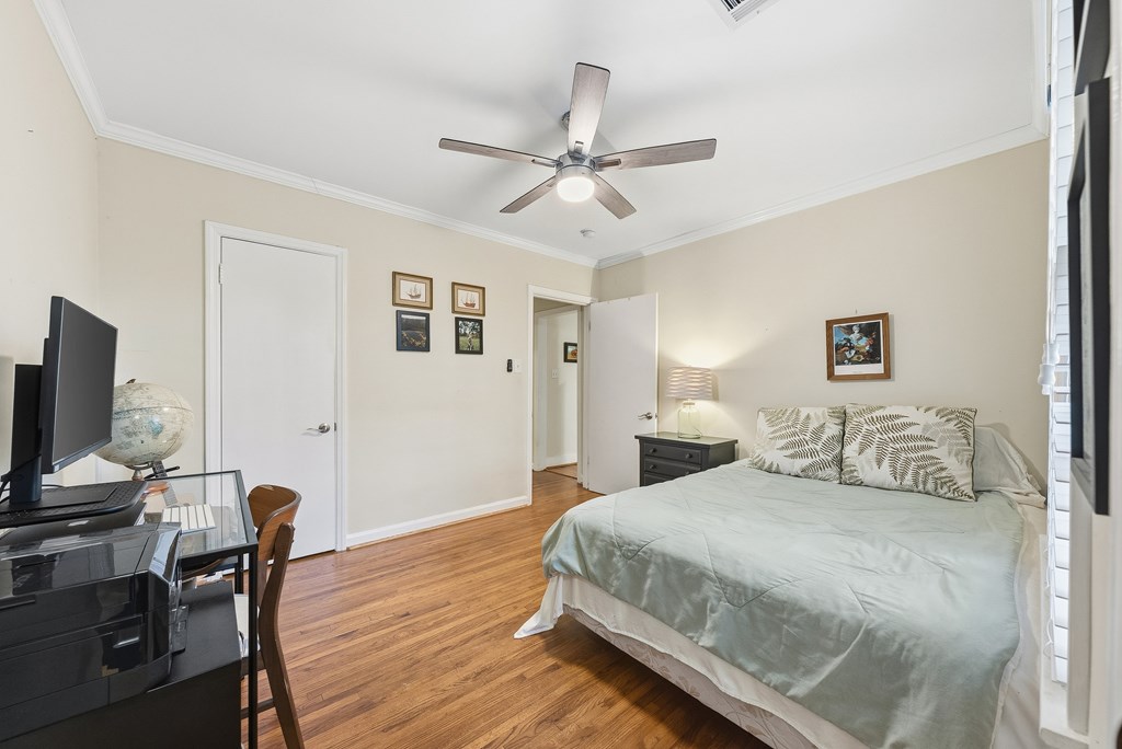 3704 East Britt David Road Columbus, GA 31909 - Photo 28 of 40 a bedroom with a bed and a flat screen tv