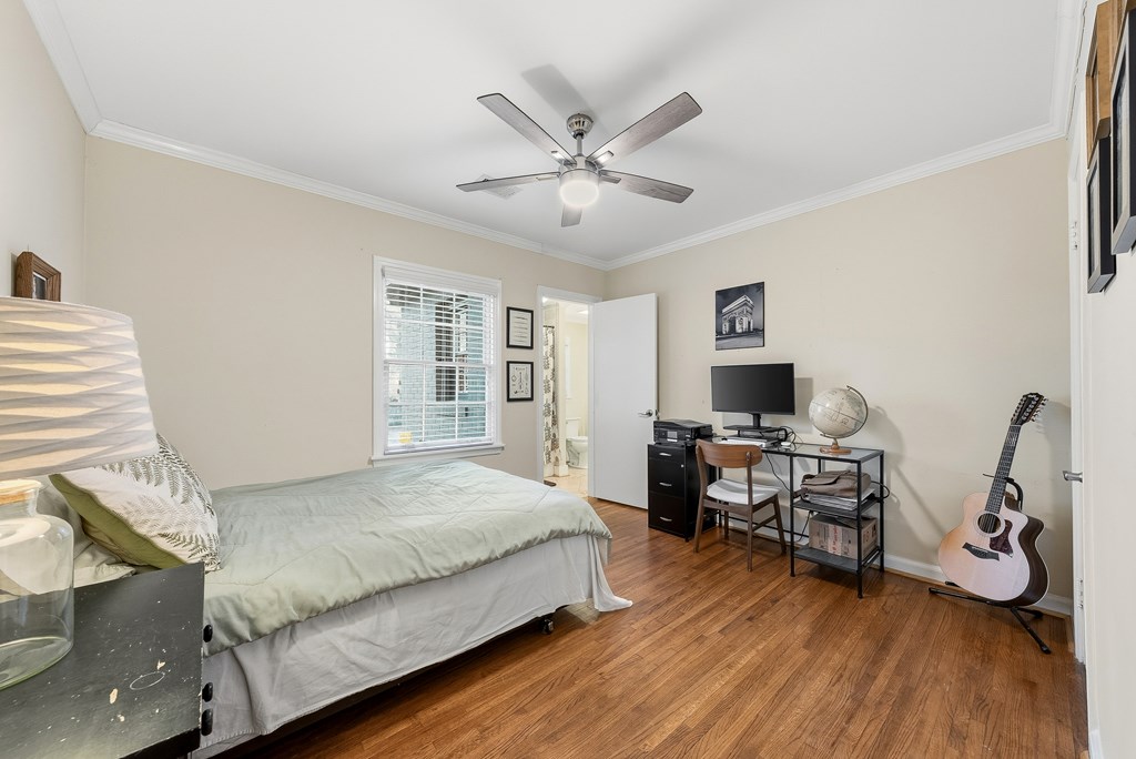3704 East Britt David Road Columbus, GA 31909 - Photo 29 of 40 a bedroom with a bed and wooden floor