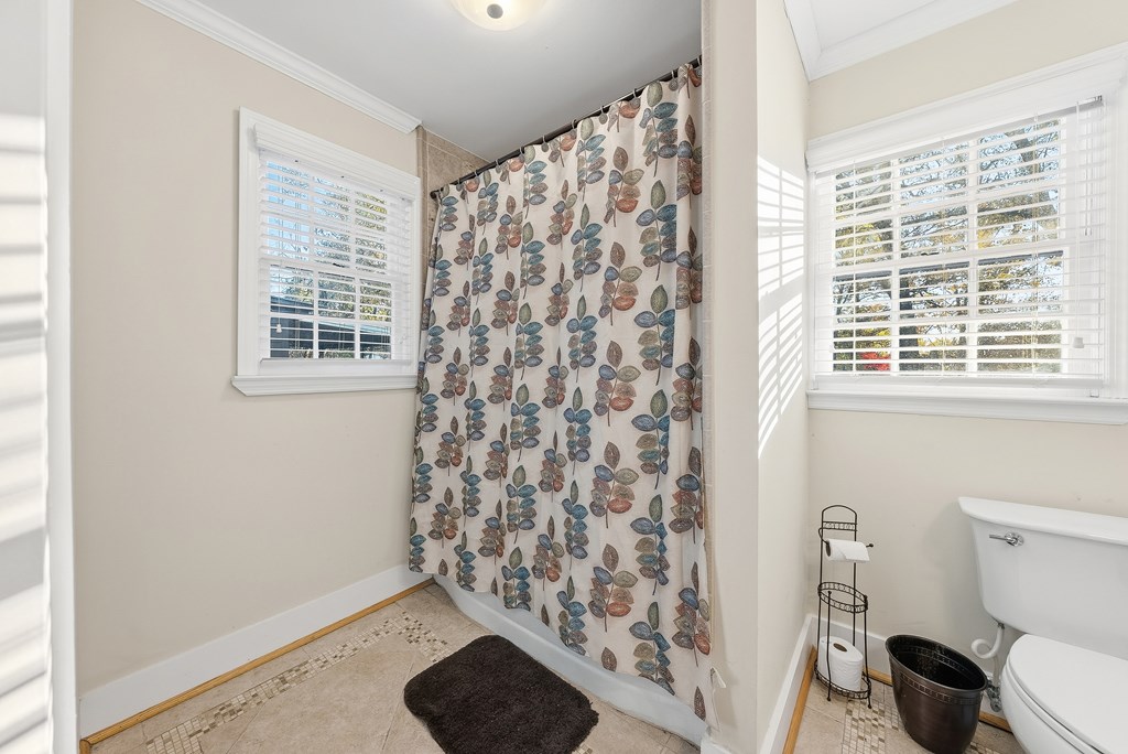 3704 East Britt David Road Columbus, GA 31909 - Photo 31 of 40 a bathroom with a toilet and a shower curtain