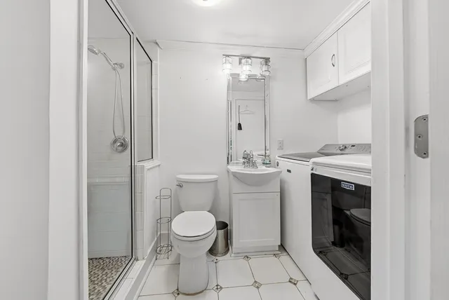 a bathroom with a sink toilet and shower
