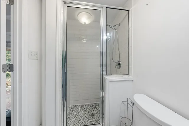 a bathroom with a toilet a sink and shower