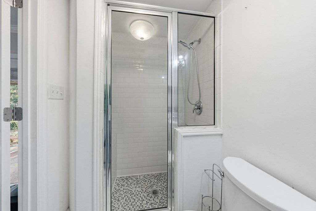 3704 East Britt David Road Columbus, GA 31909 - Photo 33 of 40 a bathroom with a toilet a sink and shower