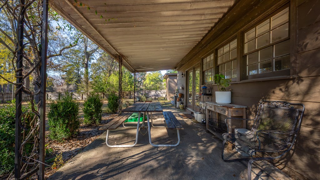 3704 East Britt David Road Columbus, GA 31909 - Photo 34 of 40 a room with lots of furniture and trees