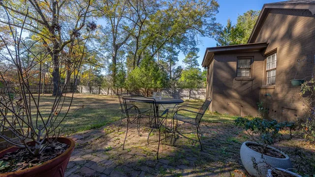 a view of a chairs and table in backyard of the house