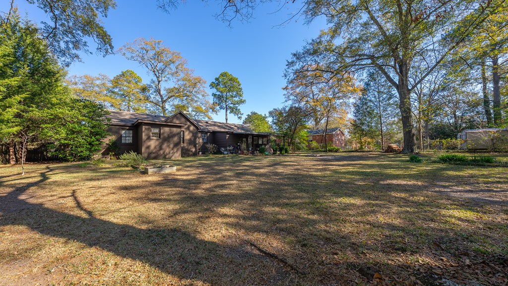 3704 East Britt David Road Columbus, GA 31909 - Photo 37 of 40 a front view of a house with a yard and trees