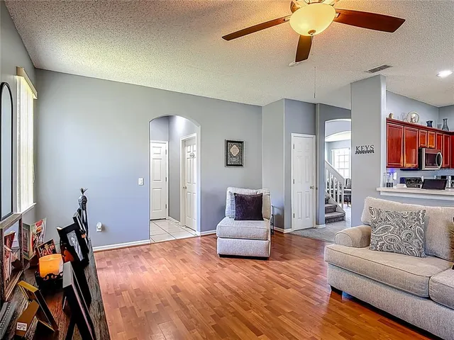 a living room with furniture and a wooden floor