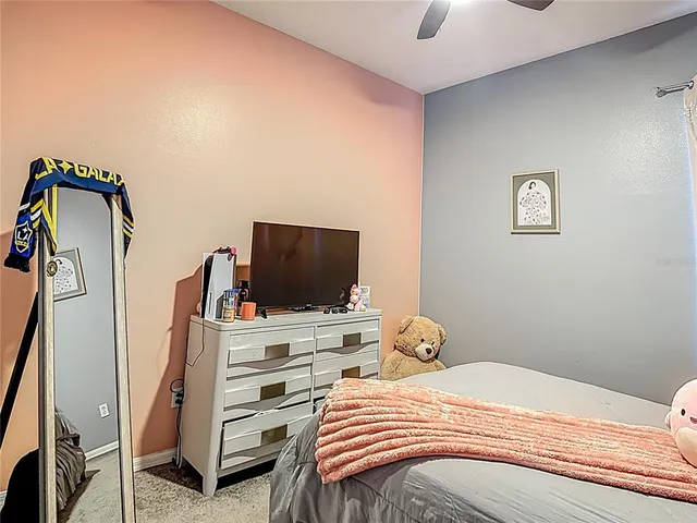 a bedroom with a bed and flat screen tv