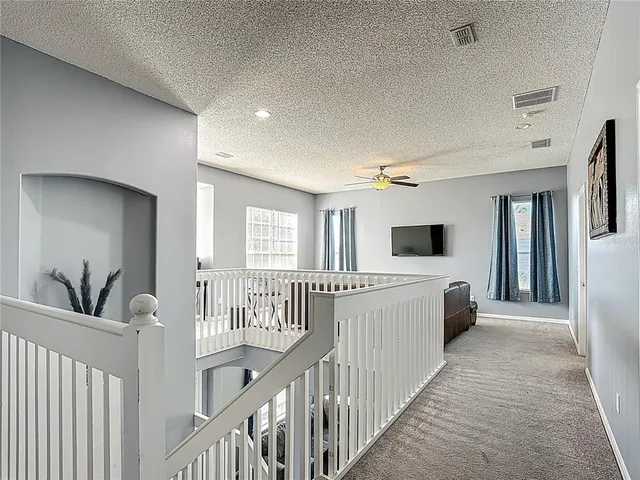 a bed room with a bed and a ceiling fan