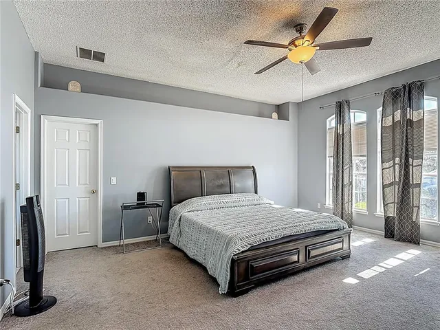 an aerial view of a house with a garden and lake view