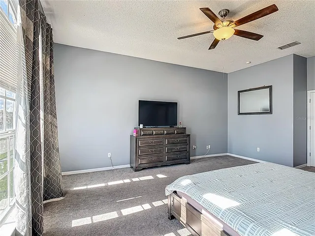 an aerial view of lake and residential houses with outdoor space