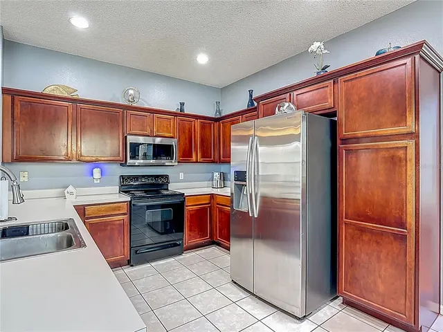 a kitchen with stainless steel appliances a stove sink and cabinets