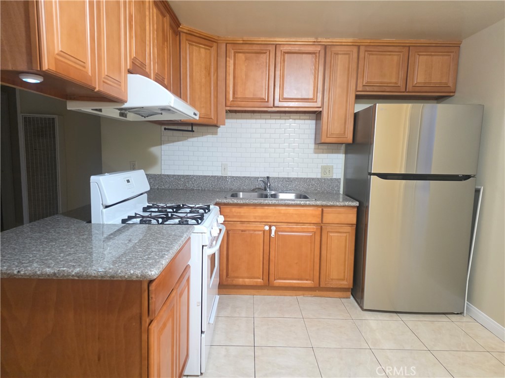 2642 Maxson Road, Unit 6 El Monte, CA 91732 - Photo 4 of 13 a kitchen with stainless steel appliances granite countertop a refrigerator sink and cabinets