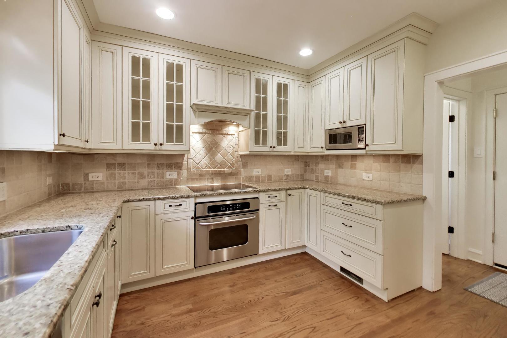 931 Pontiac Road Wilmette, IL 60091 - Photo 5 of 18 a kitchen with stainless steel appliances granite countertop a stove a sink and white cabinets