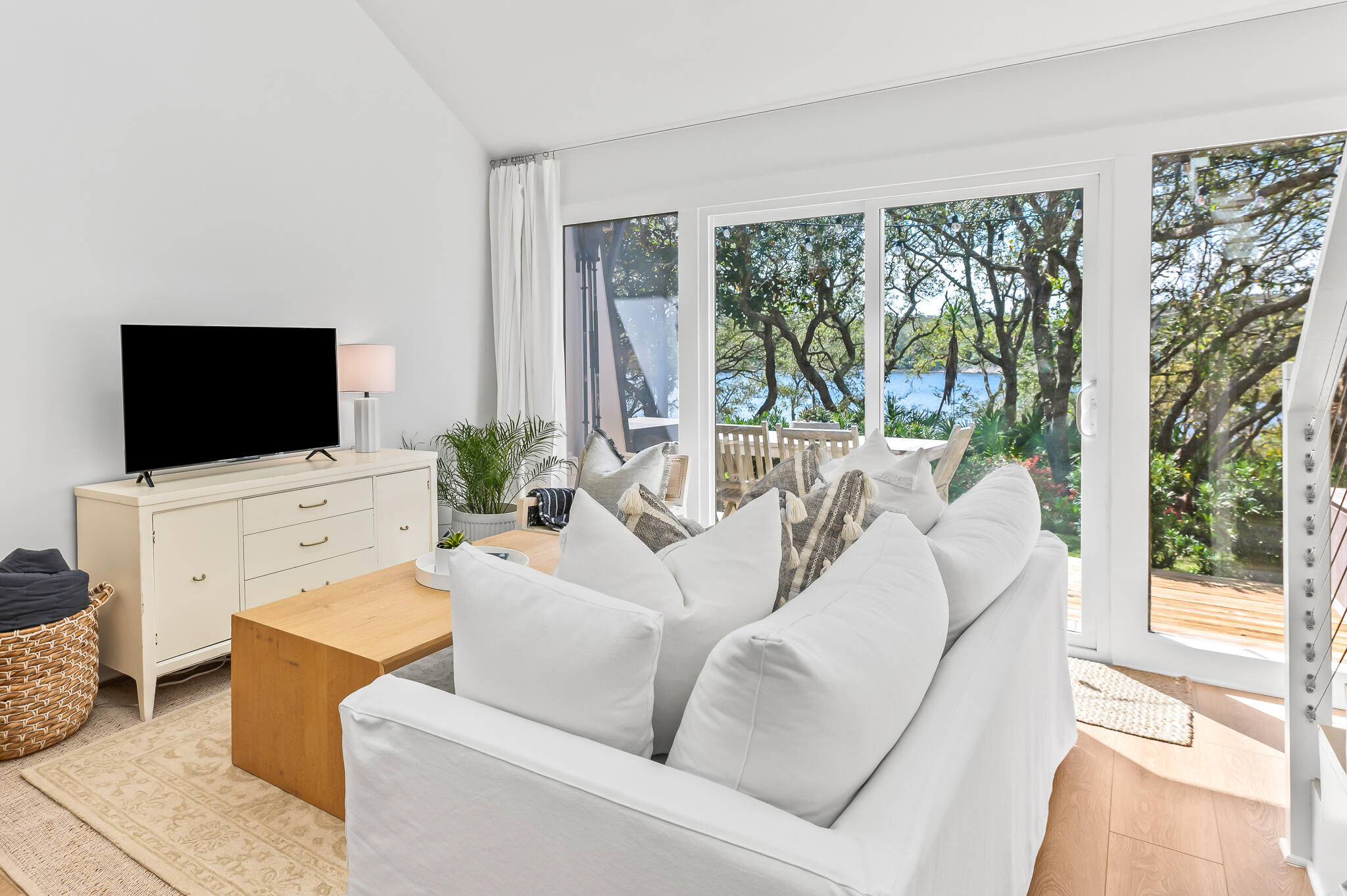 70 North Camp Creek Rd Inlet Beach, Unit 3 Inlet Beach, FL 32461 - Photo 19 of 66 a living room with furniture a flat screen tv and a floor to ceiling window