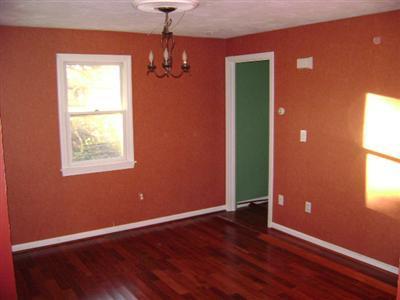 27 Hideaway Road, Unit 27G Buzzards Bay, MA 02532 - Photo 3 of 7 an empty room with wooden floor and windows