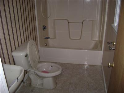 27 Hideaway Road, Unit 27G Buzzards Bay, MA 02532 - Photo 5 of 7 a bathroom with a toilet and a bathtub