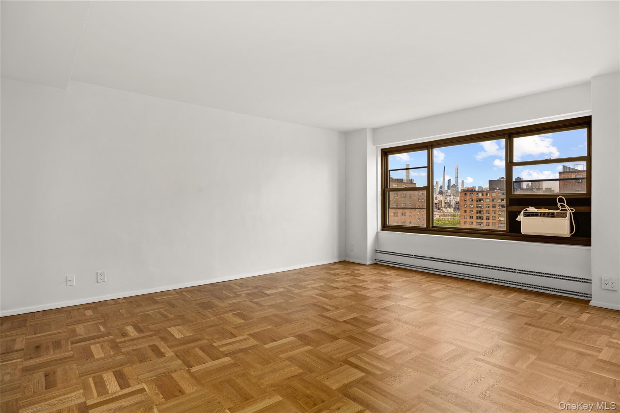21-66 33rd Road, Unit 12B Queens, NY 11106 - Photo 2 of 23 an empty room with large window
