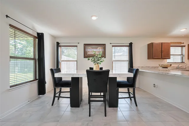 a view of a dining room with furniture and window